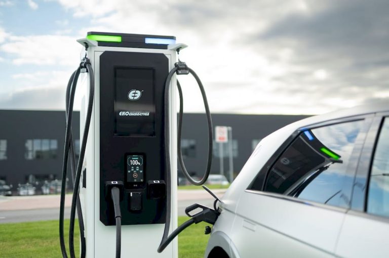Electric vehicle charger connected to sleek silver EV