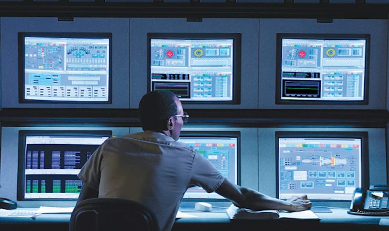 Technician operating building management control panels