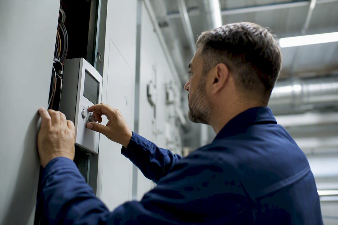 Technician hands adjusting HVAC valve
