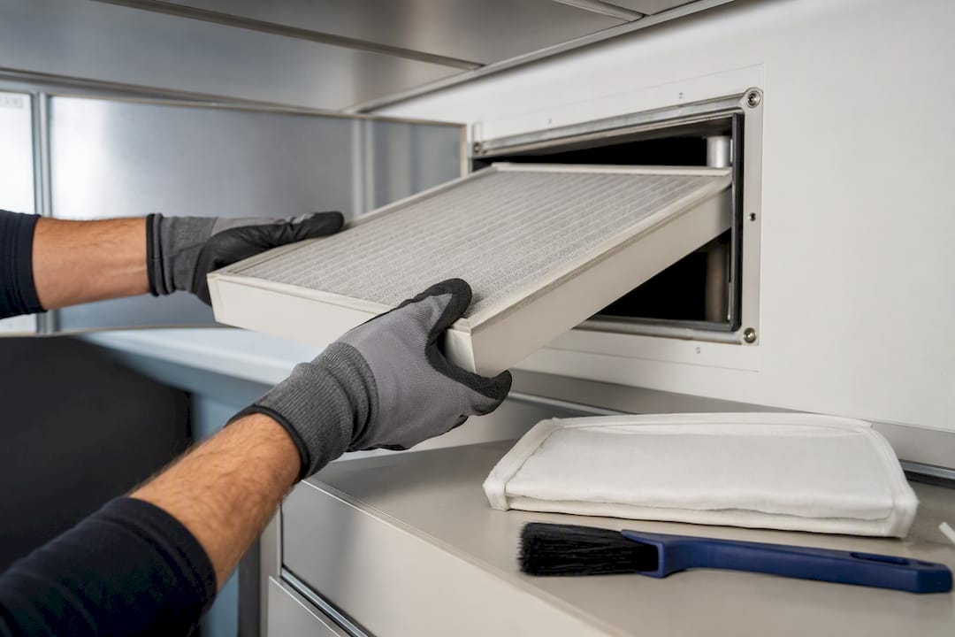 Engineer removing ventilation system filter
