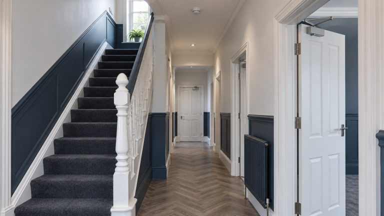Hallway of a shared house with fire doors and a smoke alarm